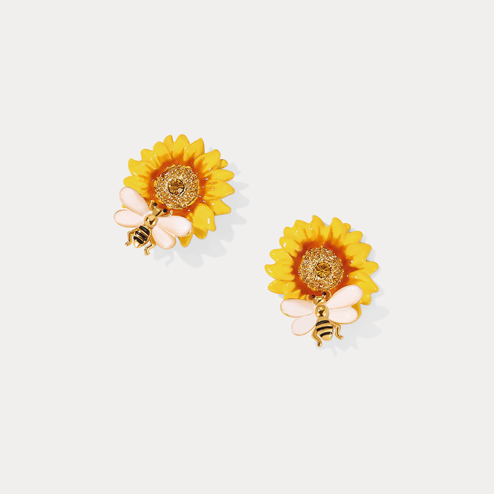 Pair of Verdivine sunflower earrings shown from the top with golden bee accents